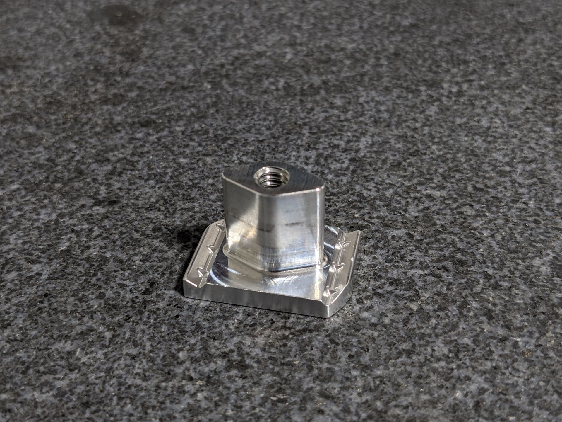 Machined aluminum block on granite surface